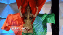 a woman in a puerto rico costume is holding a red and green flag