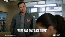 a man in a chicago fire jacket stands next to a woman and says what was that back there