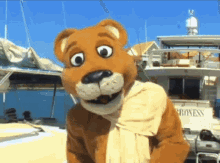 a mascot standing in front of a boat that says progress