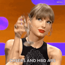 taylor swift is holding a glass of wine and says cheers and hbd abs