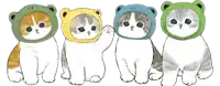 four cats wearing frog hats are lined up in a row