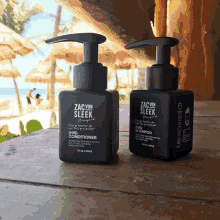 two black bottles of zac von sleek hair products on a wooden table