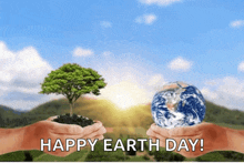 two hands holding a tree and a globe with the words happy earth day written on the bottom