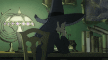 a woman in a witch hat sits in front of a lamp