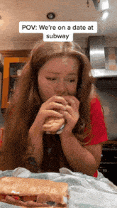 a woman is eating a subway sandwich with a caption that says pov we 're on a date at subway