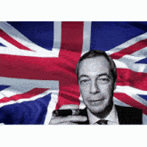 a man holding a cigar in front of a flag