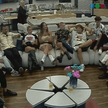 a group of people sitting on a couch with one man wearing a shirt that says ' i love you ' on it