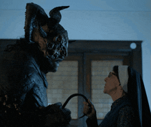a nun is holding a whip in front of a monster