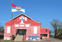 a red barn with zpc painted on the side