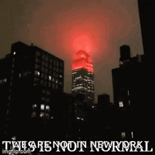 a picture of the empire state building lit up in red with the words this is not normal we are not in new york