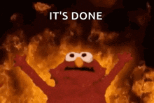 elmo from sesame street is standing in front of a wall of flames .